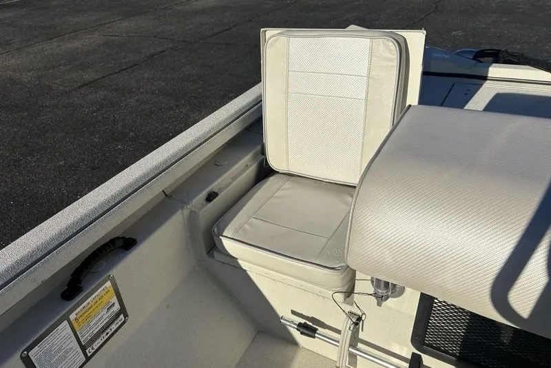 Slide: The Image of 2024 Ranger RB200 boat seat with white upholstery and storage compartment. - 31