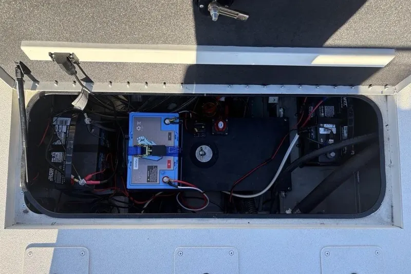 Slide: The Image of 2024 Ranger RB200 boat battery compartment with wiring and components. - 34