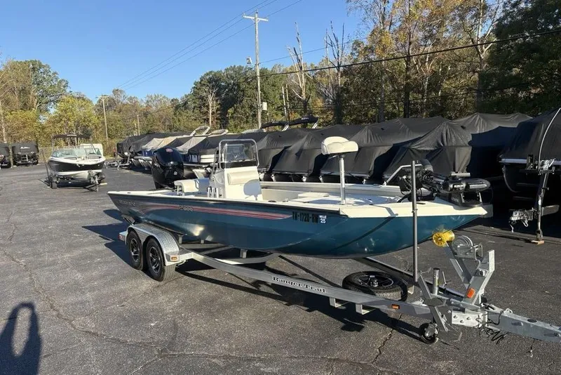 Slide: The Image of 2024 Ranger RB200 boat on trailer in outdoor lot, surrounded by covered boats. - 4