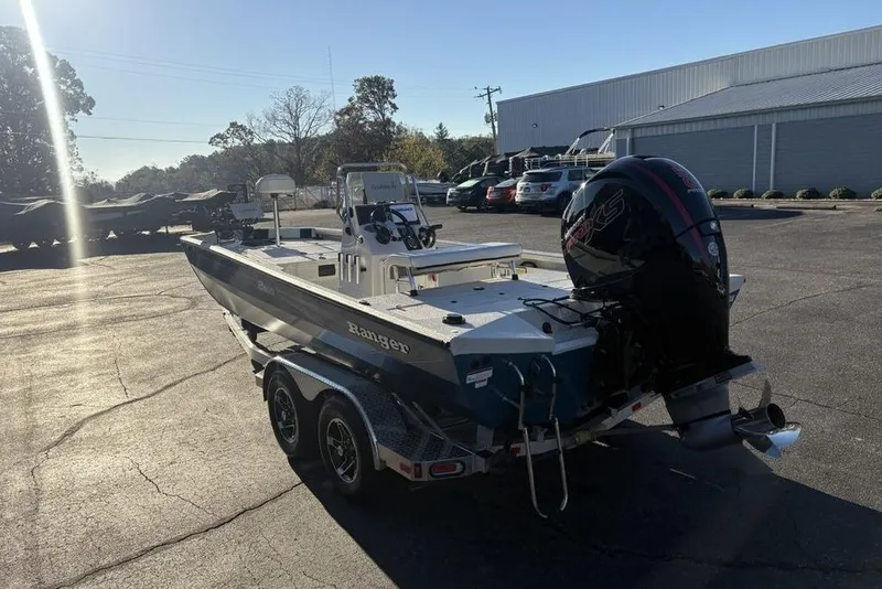Slide: The Image of 2024 Ranger RB200 boat with outboard motor on trailer in parking lot. - 9