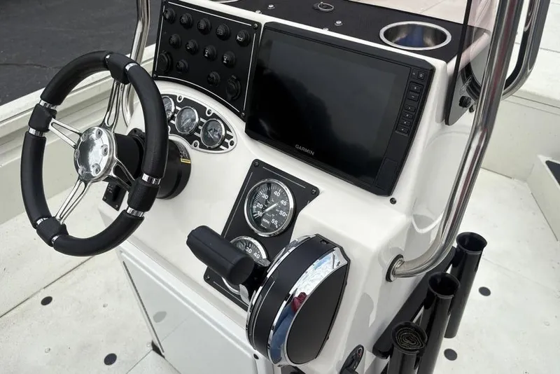 Slide: The Image of 2022 Ranger RB200 boat console with steering wheel, gauges, and Garmin display. - 11