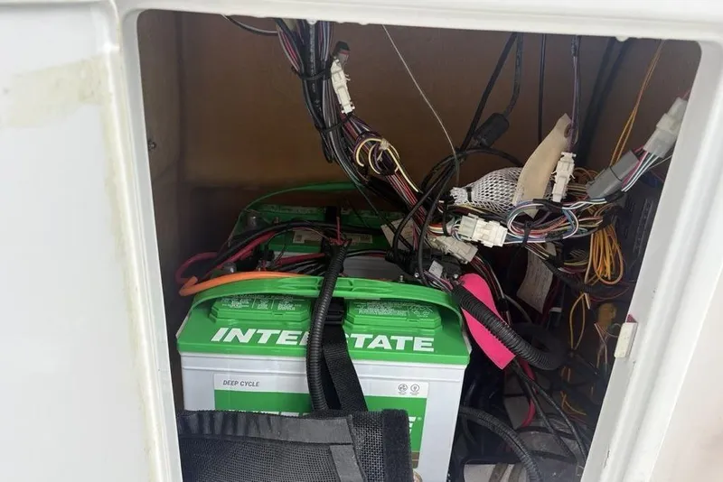 Slide: The Image of 2022 Ranger RB200 battery compartment with Interstate deep cycle battery and wiring. - 12