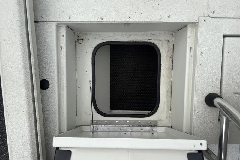 Slide: The Image of 2022 Ranger RB200 boat hatch with open compartment, showcasing interior details. - 13