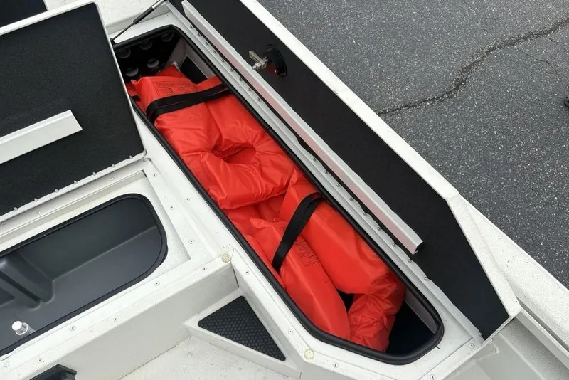Slide: The Image of Storage compartment in 2022 Ranger RB200 boat with orange life jackets. - 16