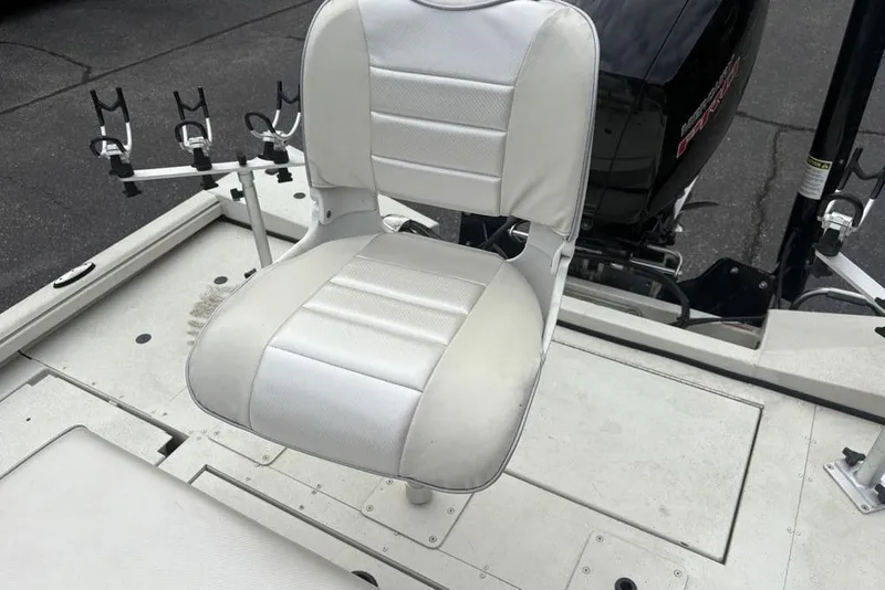 Slide: The Image of 2022 Ranger RB200 boat seat with rod holders and motor in background. - 22