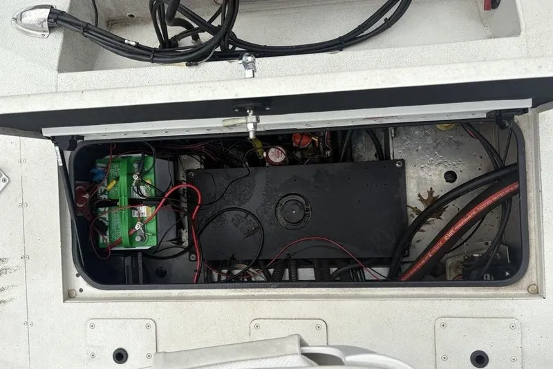 Slide: The Image of 2022 Ranger RB200 boat battery compartment with wiring and components. - 28