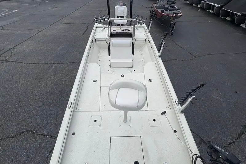 Slide: The Image of 2022 Ranger RB200 fishing boat with seating and rod holders on a paved surface. - 29