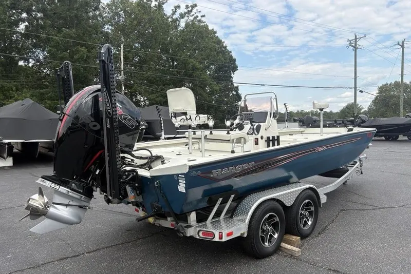 Slide: The Image of 2022 Ranger RB200 boat on trailer, featuring powerful outboard motor, parked outdoors. - 30