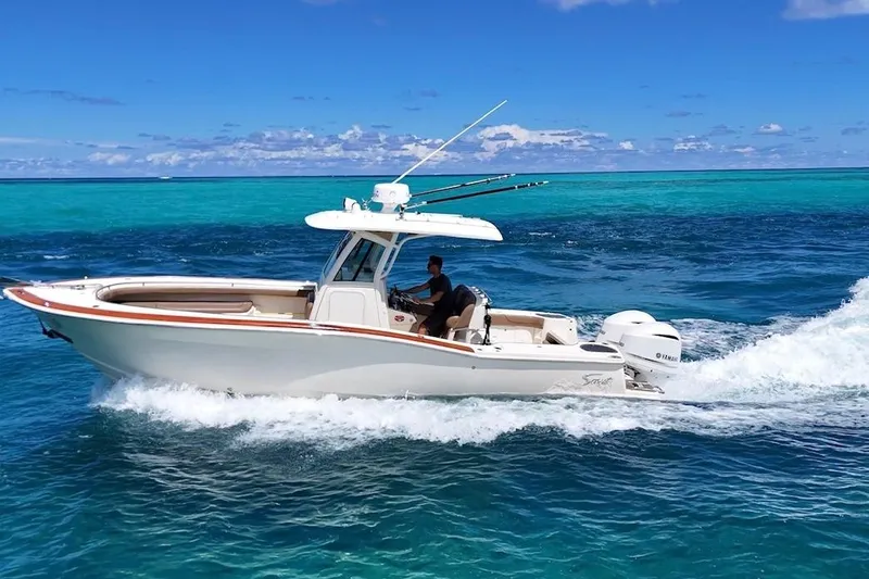 The Image of 2013 Scout 275 LXF boat cruising on clear blue ocean waters. - 0