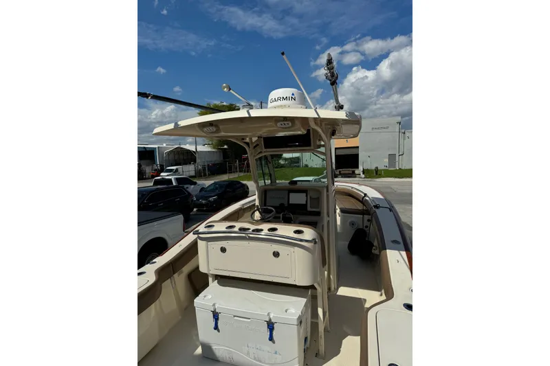 Slide: The Image of 2013 Scout 275 LXF boat with Garmin equipment, docked under a clear blue sky. - 10