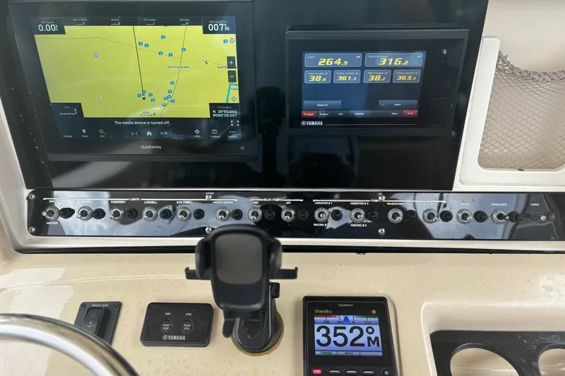 Slide: The Image of Control panel of a 2013 Scout 275 LXF boat with Garmin and Yamaha displays. - 16