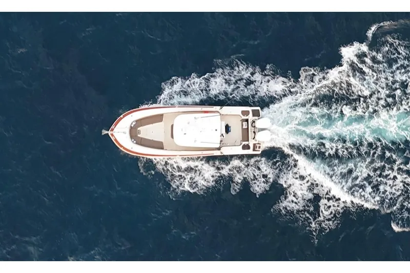 Slide: The Image of Aerial view of 2013 Scout 275 LXF boat cruising through ocean waves. - 2