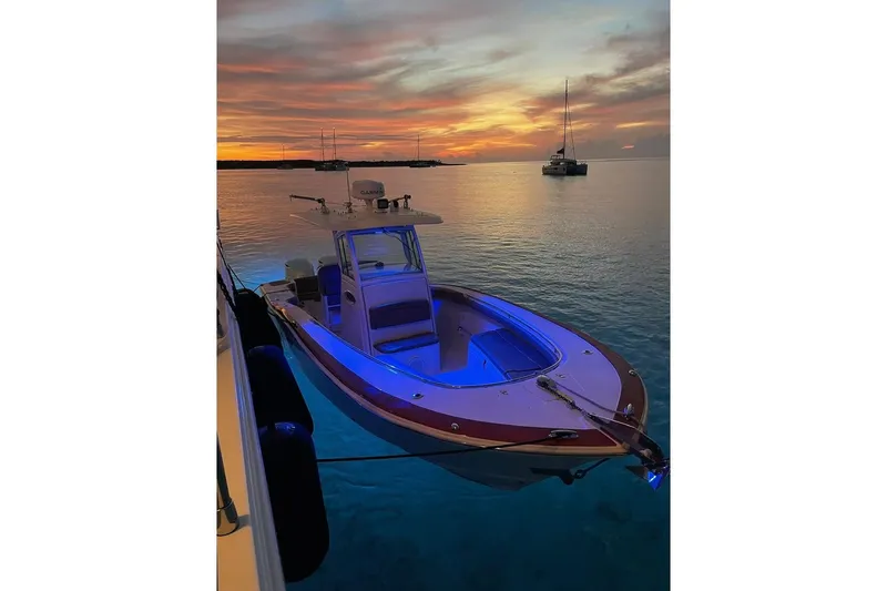 Slide: The Image of 2013 Scout 275 LXF boat at sunset, anchored in calm waters. - 5