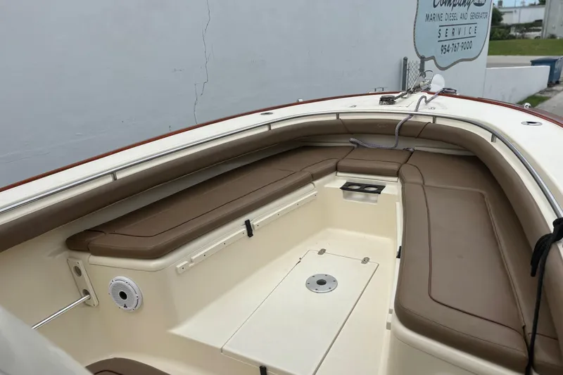 Slide: The Image of 2013 Scout 275 LXF boat interior with brown seating and cup holders. - 8