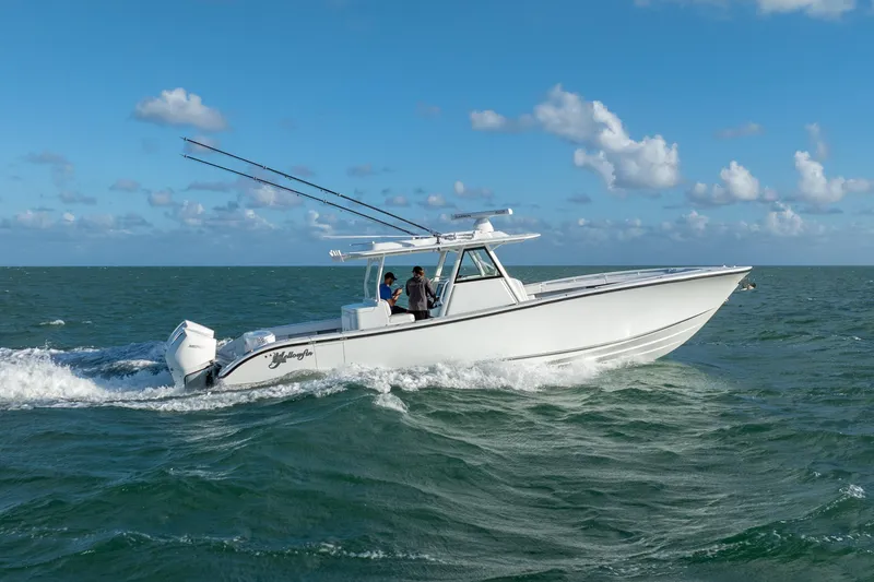 Slide: The Image of 2022 Yellowfin 39 Offshore boat cruising on open water under a clear blue sky. - 10