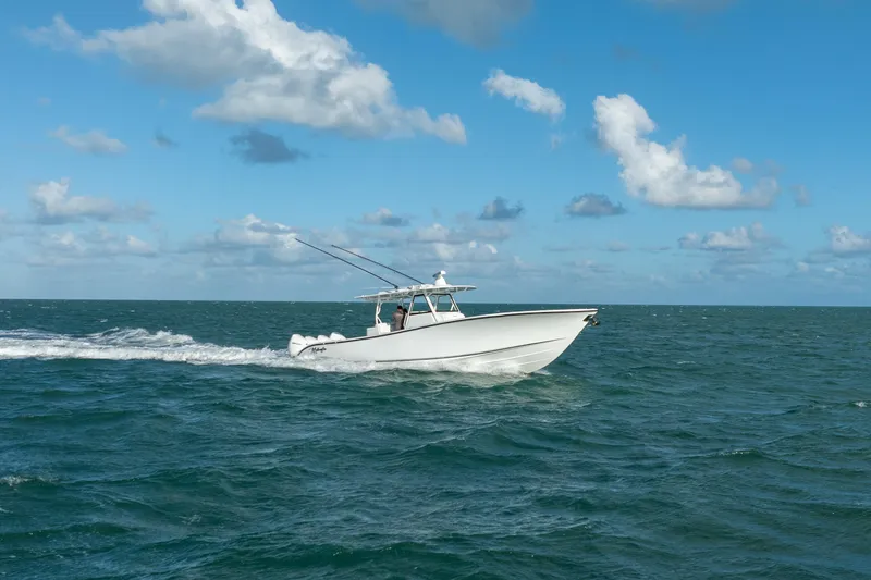 Slide: The Image of 2022 Yellowfin 39 Offshore boat cruising on open ocean under blue sky. - 11