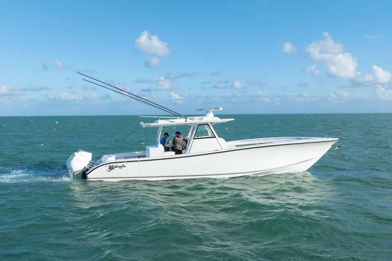 Slide: The Image of 2022 Yellowfin 39 Offshore boat cruising on open sea under clear blue sky. - 14