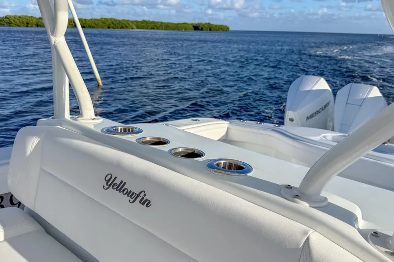 Slide: The Image of 2022 Yellowfin 39 Offshore boat with cup holders, ocean view, and Mercury engines. - 16