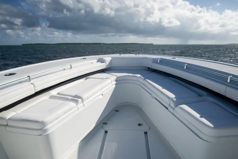 Slide: The Image of 2022 Yellowfin 39 Offshore boat with white seating, ocean view, and cloudy sky. - 20