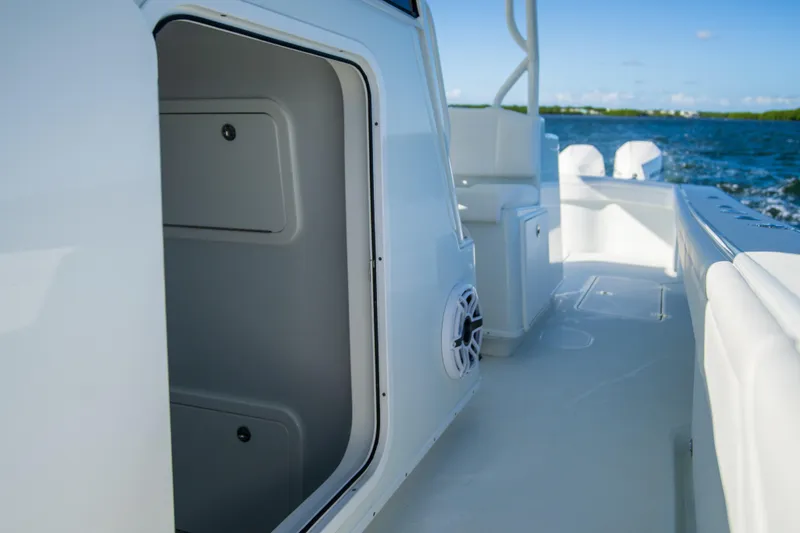 Slide: The Image of 2022 Yellowfin 39 Offshore boat interior with open storage compartment, ocean view. - 21