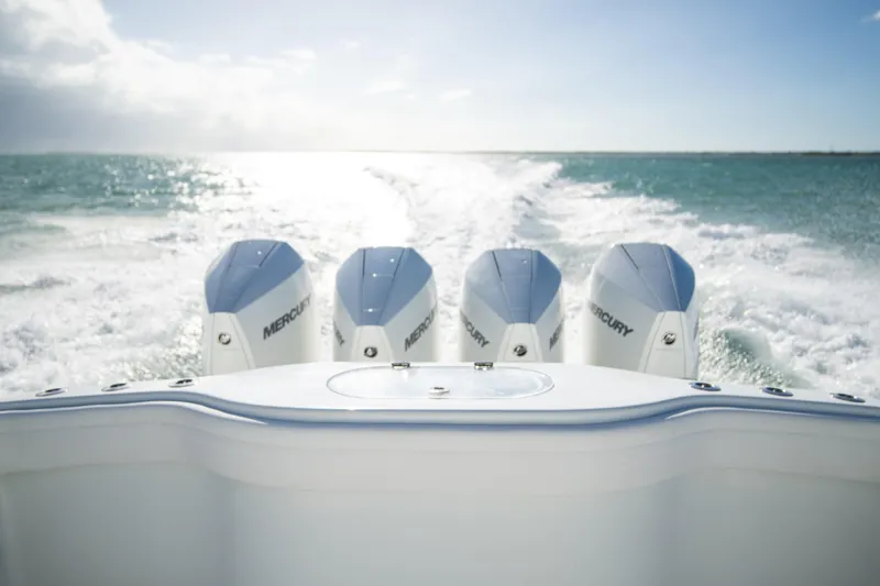Slide: The Image of 2022 Yellowfin 39 Offshore boat with four Mercury engines cruising on open water. - 23