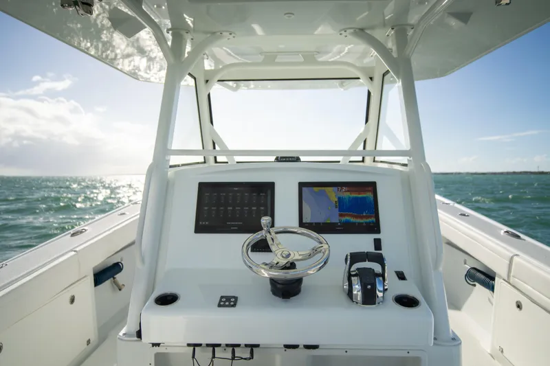 Slide: The Image of 2022 Yellowfin 39 Offshore boat console with dual screens on open water. - 24
