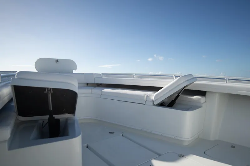 Slide: The Image of 2022 Yellowfin 39 Offshore boat interior with white seating under clear blue sky. - 29