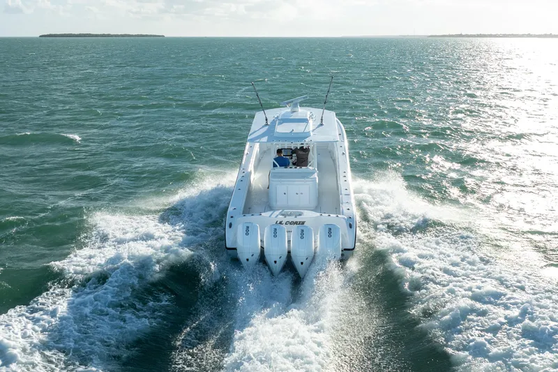 Slide: The Image of 2022 Yellowfin 39 Offshore boat cruising on open water, rear view. - 8