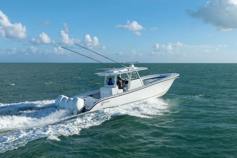Slide: The Image of 2022 Yellowfin 39 Offshore boat cruising on open water under a clear blue sky. - 9