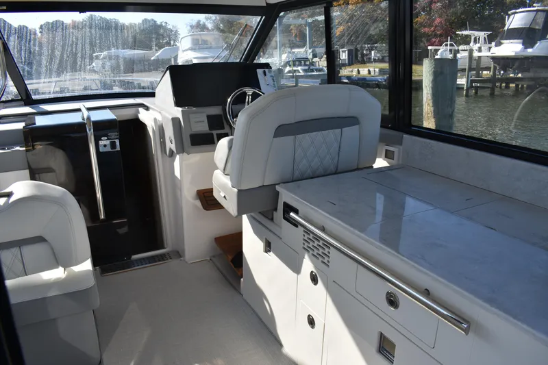 Slide: The Image of Interior of 2024 Regal 36 XO boat with helm, seating, and sleek design. - 17