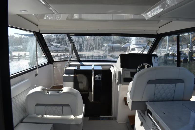 Slide: The Image of Interior of 2024 Regal 36 XO yacht, featuring modern helm and seating area. - 18