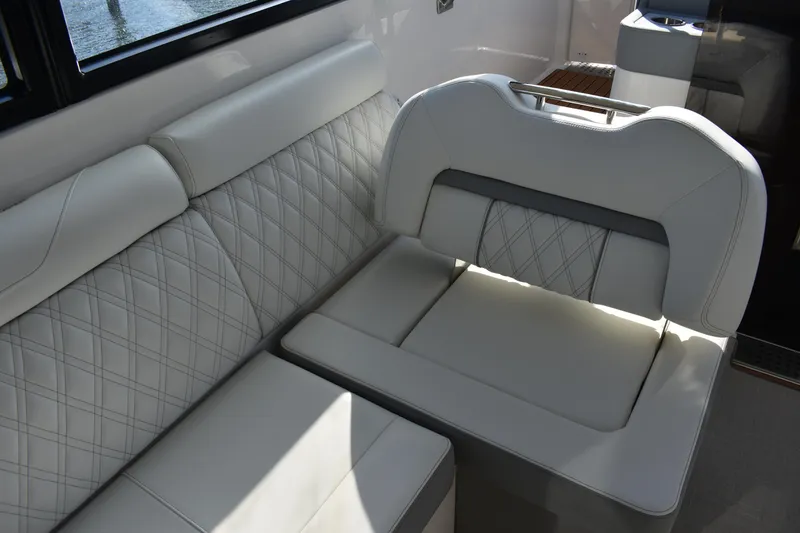 Slide: The Image of Luxurious seating on 2024 Regal 36 XO boat with elegant diamond stitching. - 23