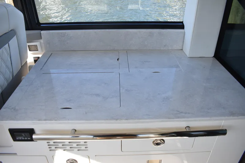 Slide: The Image of 2024 Regal 36 XO yacht interior with sleek countertop and modern design. - 24