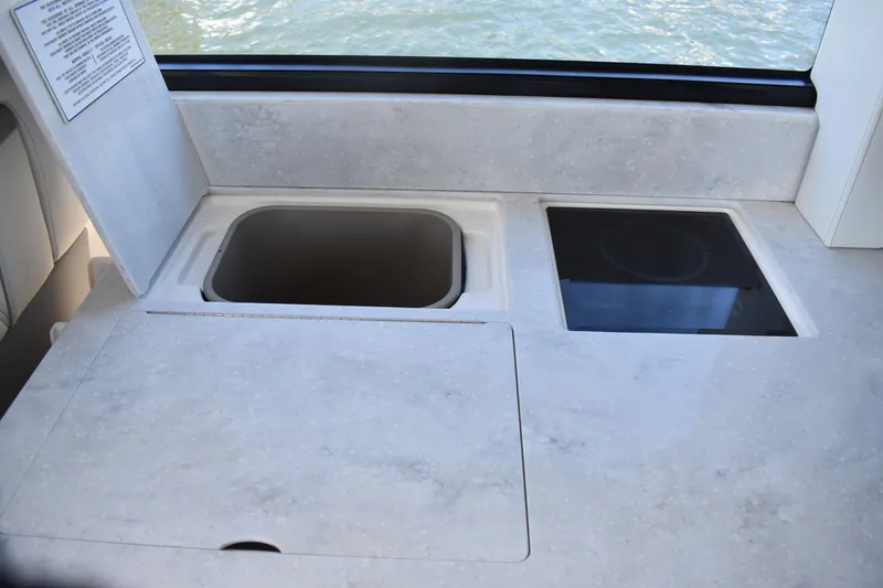 Slide: The Image of 2024 Regal 36 XO yacht kitchen countertop with sink and stove. - 25