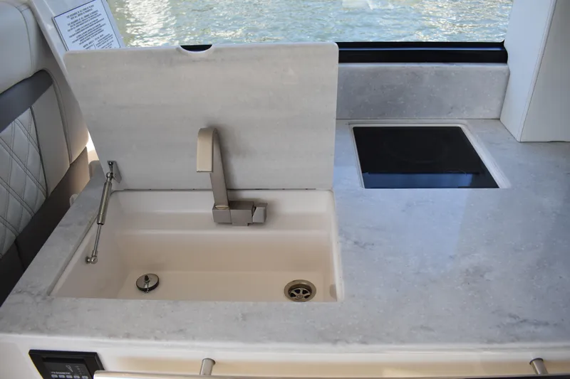 Slide: The Image of 2024 Regal 36 XO yacht kitchen with modern sink and sleek countertop design. - 26