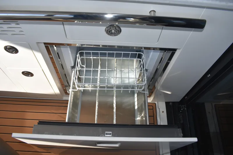 Slide: The Image of 2024 Regal 36 XO yacht interior drawer with metal basket, showcasing sleek design. - 31