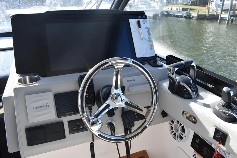 Slide: The Image of 2024 Regal 36 XO helm with Garmin navigation and modern controls. - 34