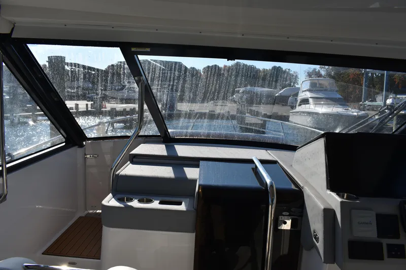 Slide: The Image of Interior view of 2024 Regal 36 XO yacht cockpit with marina background. - 39