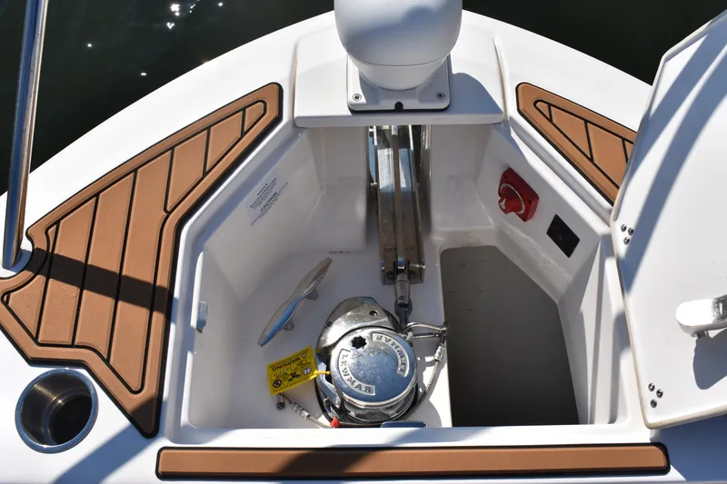 Slide: The Image of 2024 Regal 36 XO boat anchor compartment with teak accents and equipment. - 45