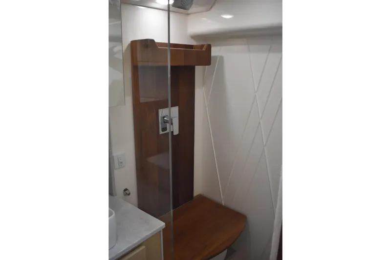 Slide: The Image of 2024 Regal 36 XO yacht bathroom with modern shower design and wooden accents. - 52
