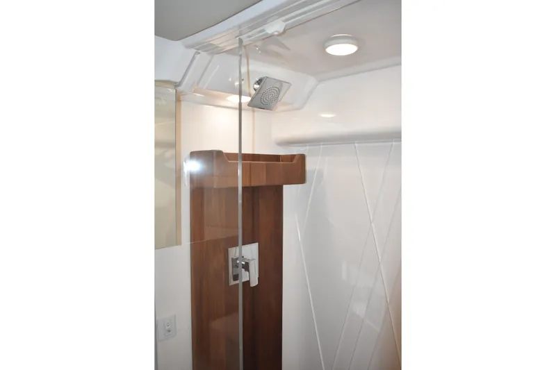 Slide: The Image of 2024 Regal 36 XO yacht shower with modern fixtures and wooden accents. - 53