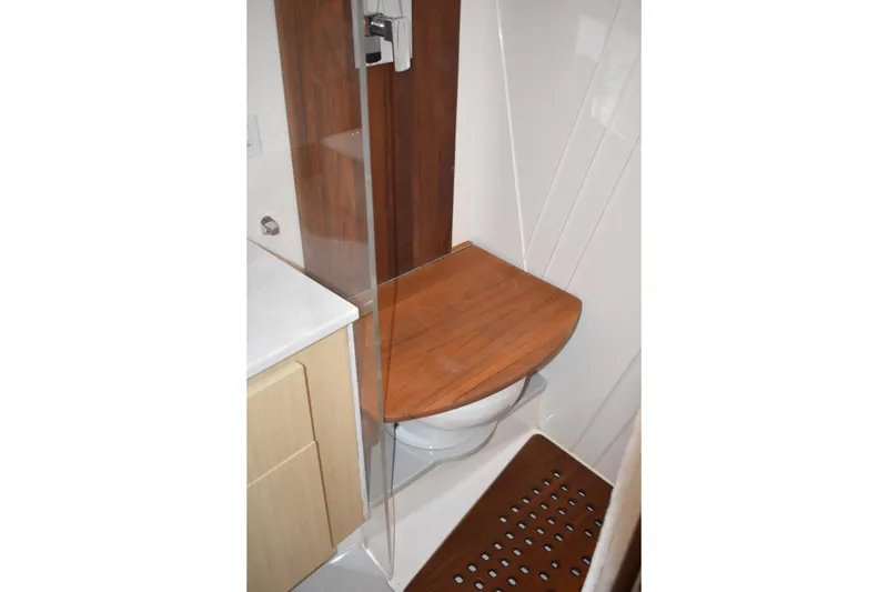 Slide: The Image of 2024 Regal 36 XO yacht bathroom with wooden seat and modern design. - 54