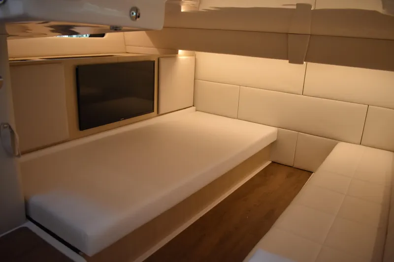 Slide: The Image of 2024 Regal 36 XO cabin interior with modern seating and wall-mounted TV. - 59