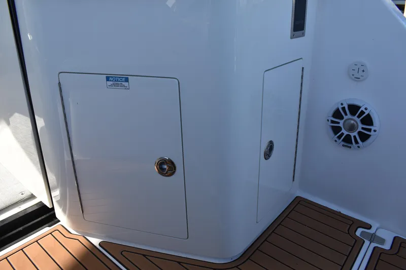 Slide: The Image of 2024 Regal 36 XO boat interior with storage compartment and speaker. - 8