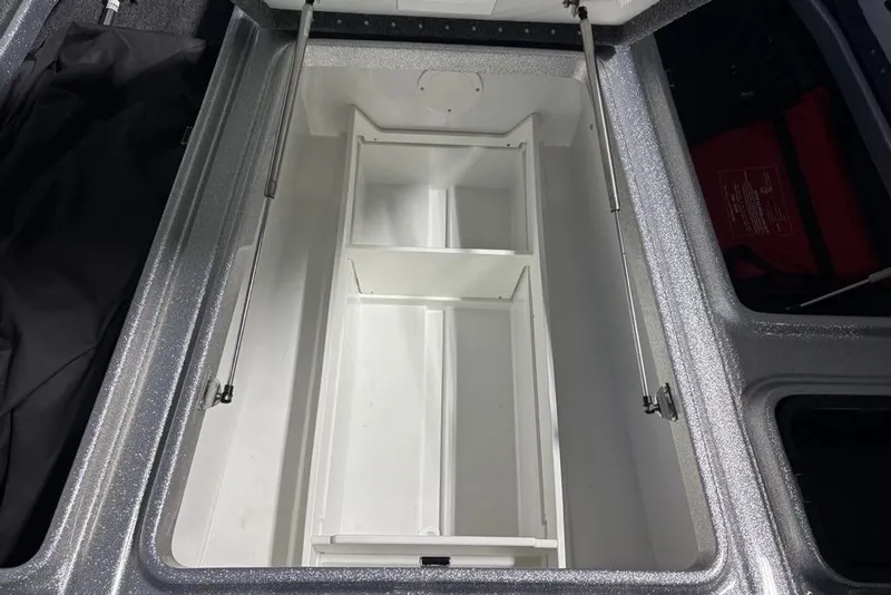 Slide: The Image of Open storage compartment in 2024 Phoenix 920 Elite boat, featuring organized interior layout. - 18