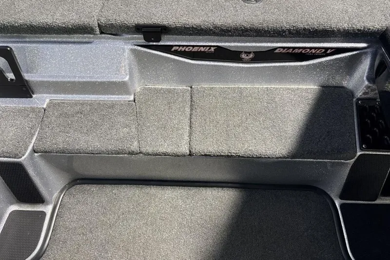 Slide: The Image of Interior of 2024 Phoenix 920 Elite boat with carpeted flooring and storage compartments. - 19