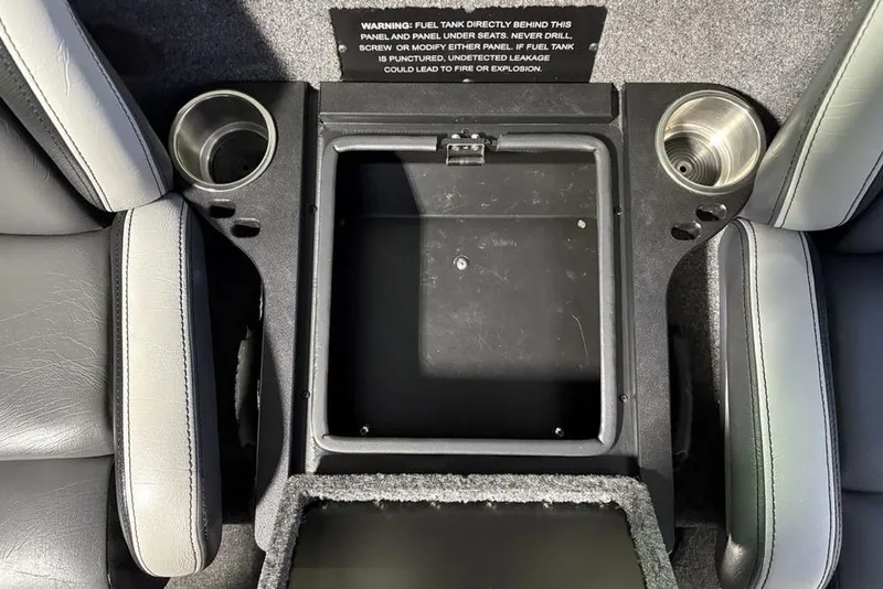 Slide: The Image of 2024 Phoenix 920 Elite interior console with cup holders and storage compartment. - 20