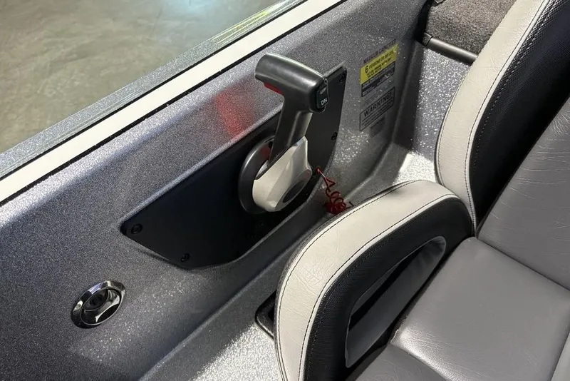 Slide: The Image of 2024 Phoenix 920 Elite boat interior with control lever and gray seating. - 27