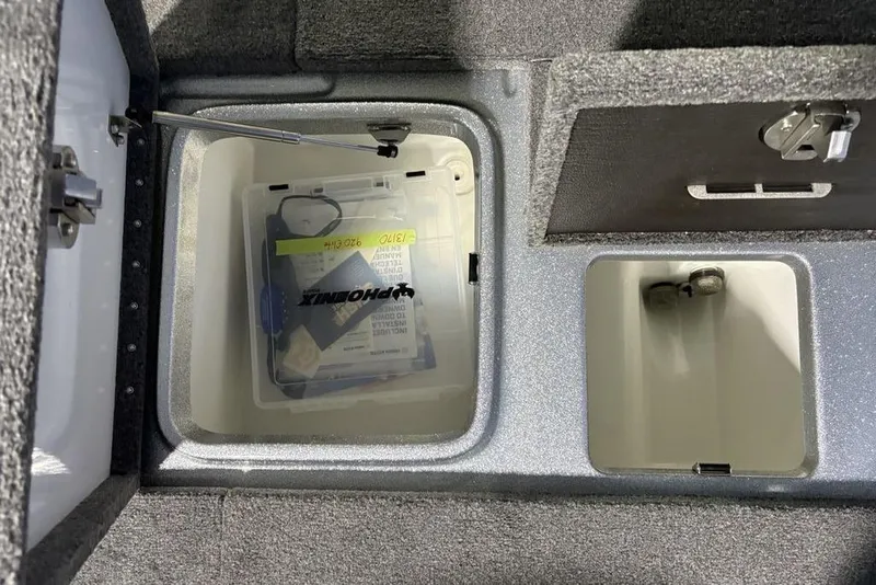 Slide: The Image of Storage compartments in a 2024 Phoenix 920 Elite boat, featuring organized tackle boxes. - 29
