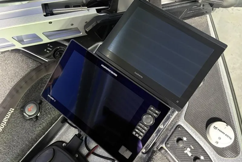 Slide: The Image of 2024 Phoenix 920 Elite boat dashboard with Garmin and Humminbird displays. - 3